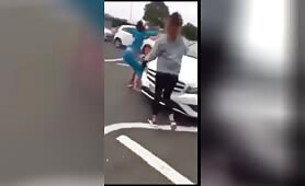 English women fighting in the middle of the road